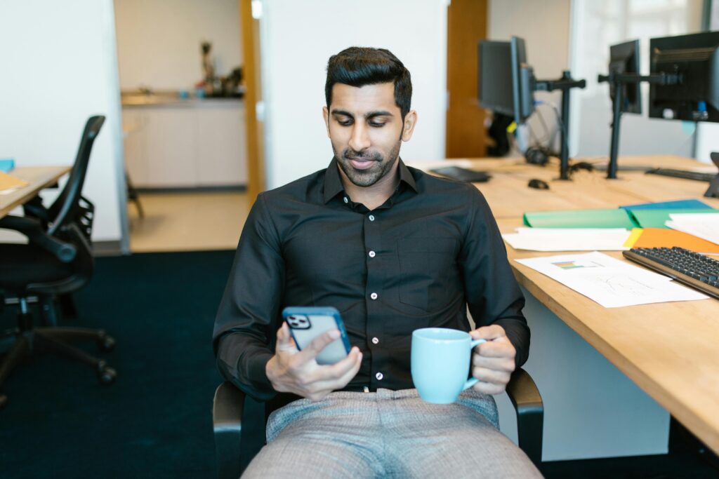 Man in Black Dress Shirt Holding Blue Ceramic Mug